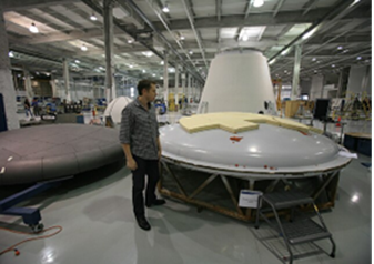A person standing next to a large white object

AI-generated content may be incorrect.